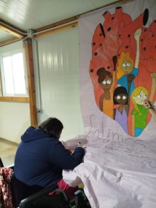 Personas haciendo mural por el dia de la mujer