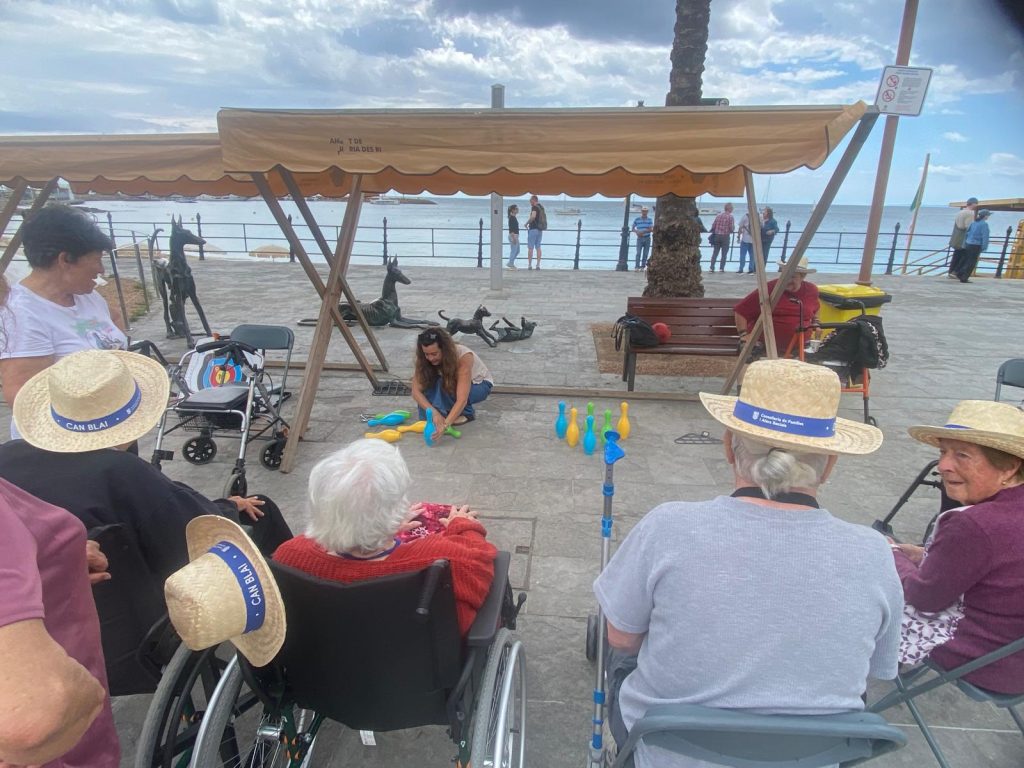 Personas mayores en la playa jugando a los bolos