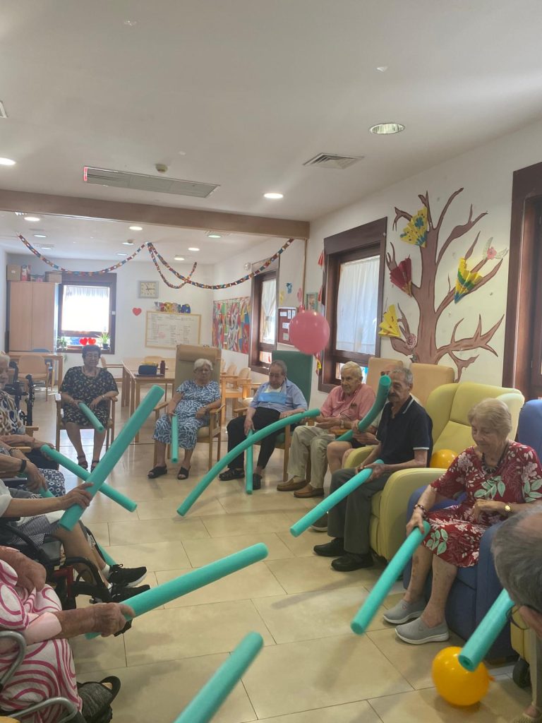 Personas mayores jugando a tenis con globos