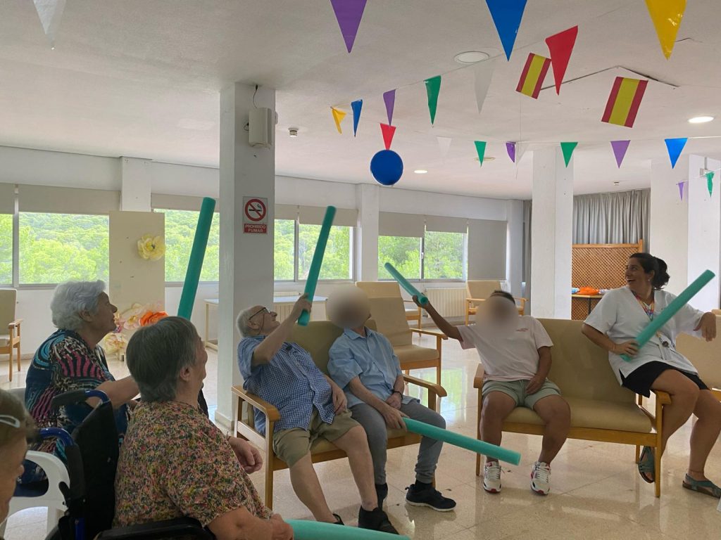 Personas mayores jugando a tenis con globos